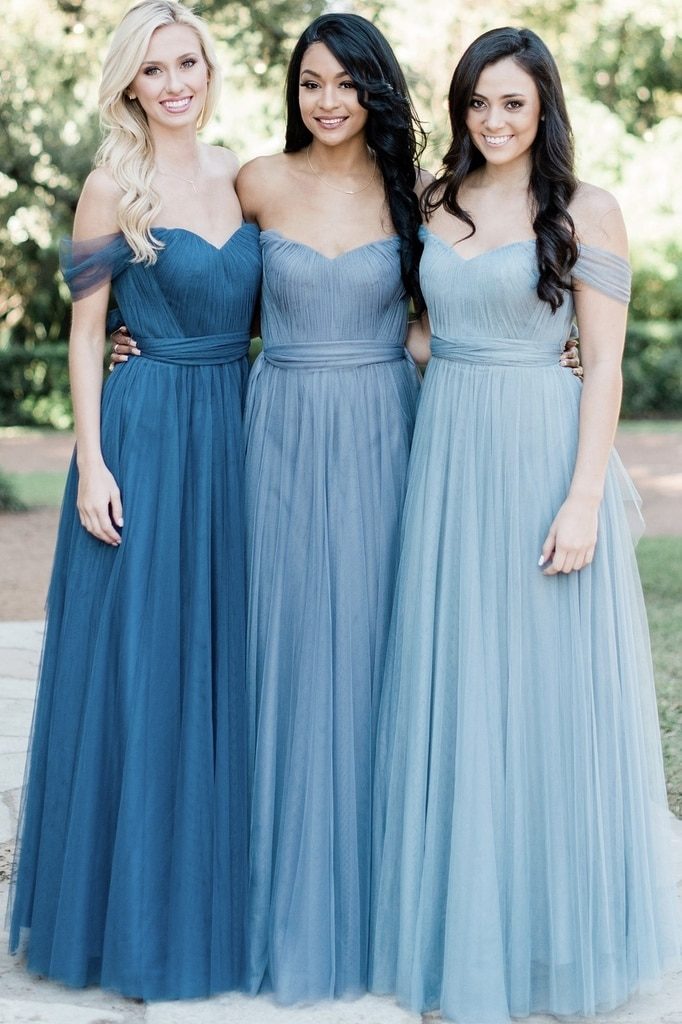 Three women showing off Revelry's bridesmaid dress selection