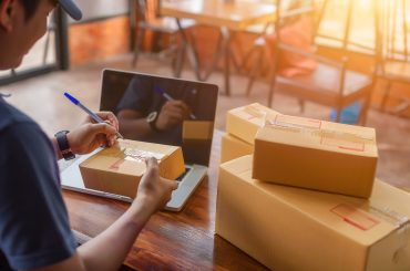 Delivery driver picking up shipment from eCommerce retailer's location