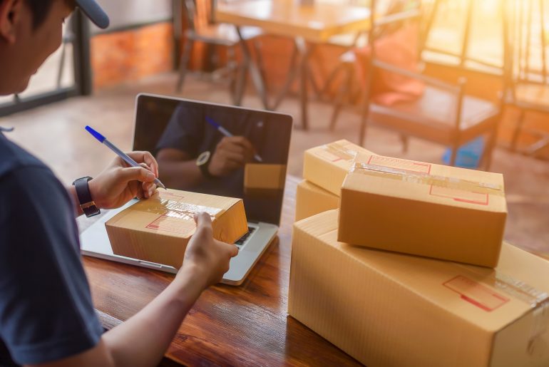 Delivery driver picking up shipment from eCommerce retailer's location
