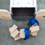 Man unloading truck of packages after visiting multiple warehouses