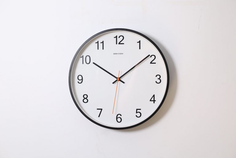 clock against wall to represent estimated delivery dates
