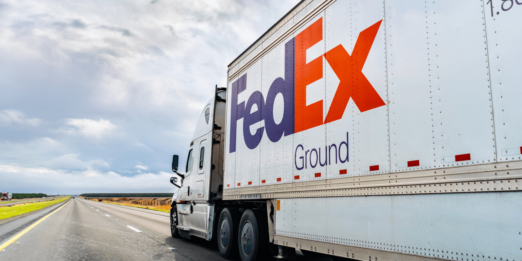 FedEx Ground truck drives on open highway