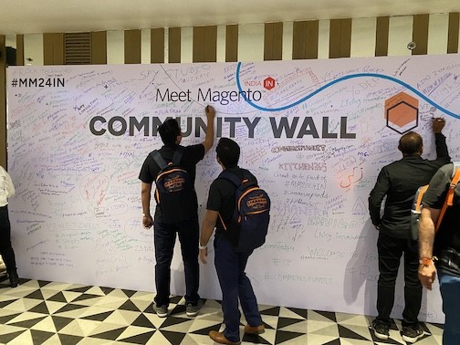 Meet Magento India 2024 attendees signing the community wall